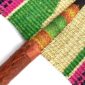 Close-up of the weave and leather handle on the green and pink Bolga fan