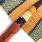 Close-up of the weave and leather handle on the orange and black Bolga fan