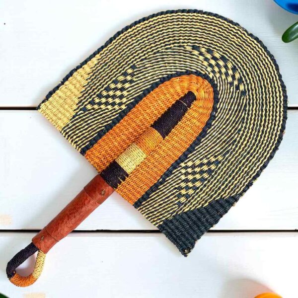 Woven Bolga hand fan in orange and black with a leather-wrapped handle