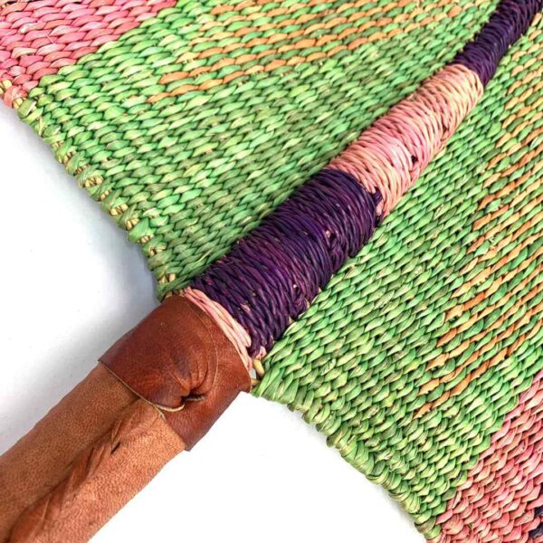 bashiri-fan-s1-278-airbourne-bolga-hand-fan-woven-2 Close-up of the weave and leather handle on the pink and green Bolga fan