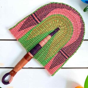 Woven Bolga hand fan in pink and green with a leather-wrapped handle