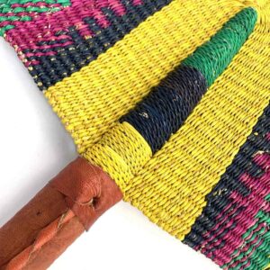 Close-up of the weave and leather handle on the yellow and green Bolga fan