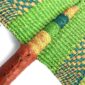 Close-up of the weave and leather handle on the green and teal Bolga fan