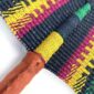 Close-up of the weave and leather handle on the navy and yellow Bolga fan