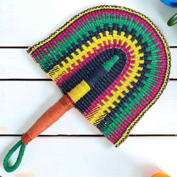 Woven Bolga hand fan in navy and yellow with a leather-wrapped handle