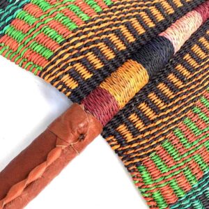 Close-up of the weave and leather handle on the green and orange Bolga fan