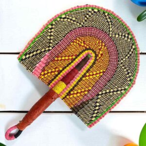 Woven Bolga hand fan in pink and orange with a leather-wrapped handle