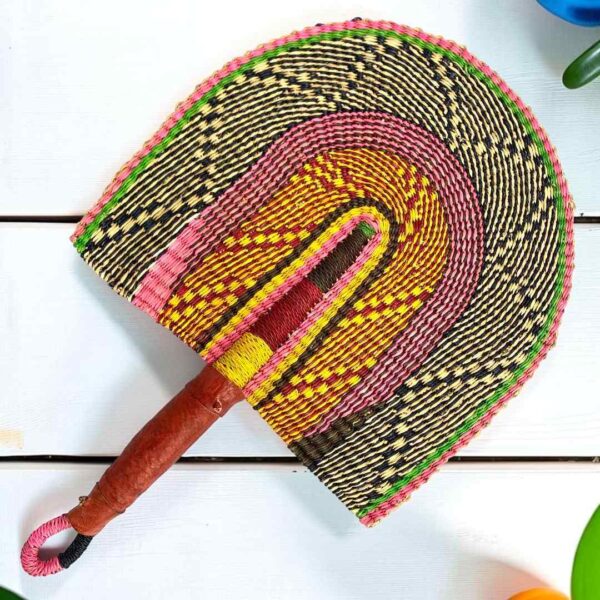 Woven Bolga hand fan in pink and orange with a leather-wrapped handle