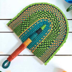 Woven Bolga hand fan in lime and teal with a leather-wrapped handle