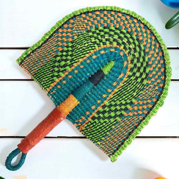 Woven Bolga hand fan in lime and teal with a leather-wrapped handle