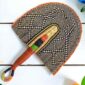 Woven Bolga hand fan in black and orange with a leather-wrapped handle