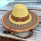 Wide brim Bolga hat with a natural crown and orange and brown band