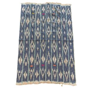 Full view of the indigo cotton cloth with columns of pale diamond motifs on a white background