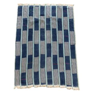 Full view of the indigo cotton cloth with solid and pinstriped panels on a white background
