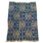 Full view of the indigo cotton cloth with chains of warm-toned diamonds on a white background