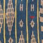 Close-up of the indigo cotton cloth with chains of warm-toned diamonds