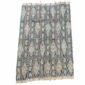 Full view of the faded indigo cotton cloth with pale diamond lattice motifs on a white background