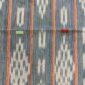 Close-up of the faded indigo cotton cloth with pale diamond lattice motifs