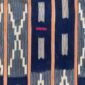 Close-up of the dark indigo cotton cloth with pale zigzag and window motifs