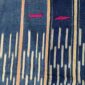 Close-up of the deep blue cotton cloth with columns of pale dashes
