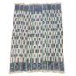 Full view of the pale cotton cloth with a stepped pattern of indigo blocks on a white background