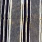Close-up of the grey-blue cotton cloth with bands of dark and pale stripes