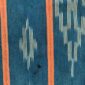 Close-up of the green-blue cotton cloth with pale diamond motifs