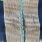 Close-up of the pale striped cotton cloth with narrow indigo motif columns