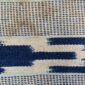 Close-up of the pale striped cotton cloth with narrow indigo motif columns