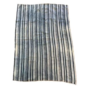 bashiri-indigo-cotton-247-sunyani-handwoven-african-fabric-2 Full view of the pale cotton cloth with faded indigo stripes on a white background
