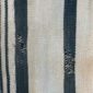 Close-up of the pale cotton cloth with faded indigo stripes