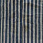Close-up of the deep indigo cotton cloth with fine pale pinstripes