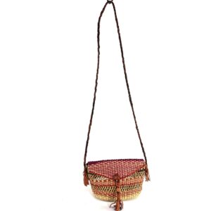 Full view of the red and purple mini Bolga shoulder bag with its plaited strap and leather tassels
