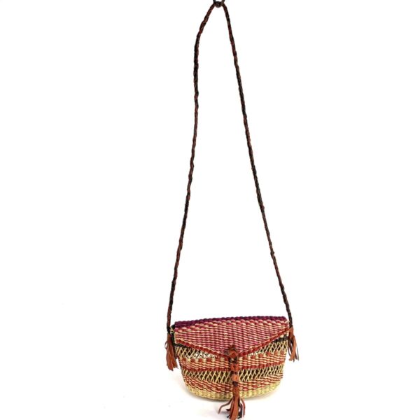 bashiri-mini-shoulder-bag-001-dollyparton-red-purple-woven-bolga-handbag-2 Full view of the red and purple mini Bolga shoulder bag with its plaited strap and leather tassels
