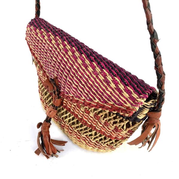 bashiri-mini-shoulder-bag-001-dollyparton-red-purple-woven-bolga-handbag-3 Close-up of the woven flap and leather toggle on the red and purple mini Bolga shoulder bag