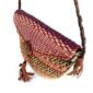 Close-up of the woven flap and leather toggle on the red and purple mini Bolga shoulder bag