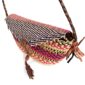 Close-up of the woven flap and leather toggle on the purple and pink mini Bolga shoulder bag