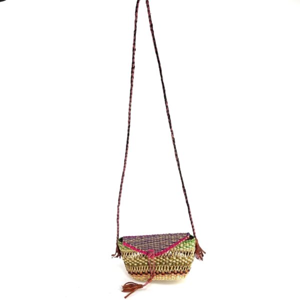 bashiri-mini-shoulder-bag-004-wendy-purple-green-woven-crossbody-bag-bolga-2 Full view of the purple, pink, and green mini Bolga shoulder bag with its plaited strap and leather tassels