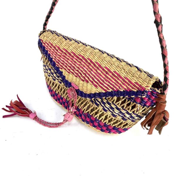 bashiri-mini-shoulder-bag-005-bella-pink-purple-woven-bolga-handbag-3 Close-up of the woven flap and leather toggle on the pink and purple mini Bolga shoulder bag