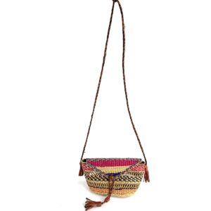 Full view of the pink, black, and orange mini Bolga shoulder bag with its plaited strap and leather tassels