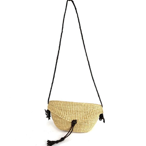 bashiri-mini-shoulder-bag-007-clutch-natural-bolga-bag-handwoven-2 Full view of the natural undyed mini Bolga shoulder bag with its plaited strap and leather tassels