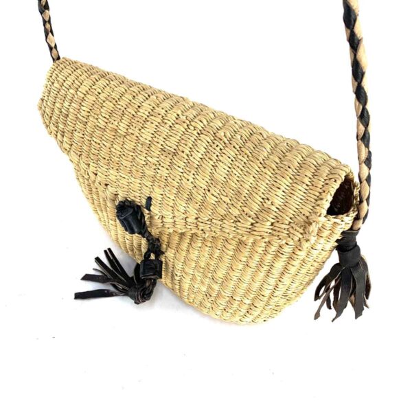 bashiri-mini-shoulder-bag-008-9to5-natural-black-woven-crossbody-bag-bolga-3 Close-up of the woven flap and leather toggle on the natural undyed mini Bolga shoulder bag