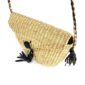 Close-up of the woven flap and leather toggle on the natural undyed mini Bolga shoulder bag