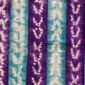 Close-up of the mudcloth with alternating jewel-toned strips and pale chevrons