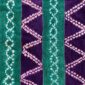 Close-up of the mudcloth with jewel-toned strips and pale chain and zigzag patterns