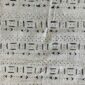 Close-up of the light mudcloth with fine rows of dark dashes and arrows