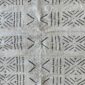 Close-up of the light mudcloth with a grid of dark stars and chevrons