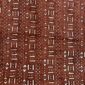 Close-up of the red-earth mudcloth densely patterned with pale dashes and dots
