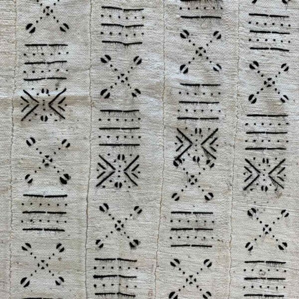 bashiri-mudcloth-small-159-cricket-african-mud-cloth-fabric-3 Close-up of the light mudcloth with columns of dark crosses and cowrie shapes