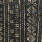 Close-up of the dark mudcloth with columns of pale diamonds and circles